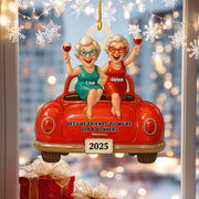 Decorative ornament with two women in a car, holding drinks, with personalized names and year.
