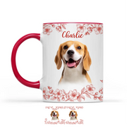 Mug with a dog's face printed on it, featuring a red handle and floral design.