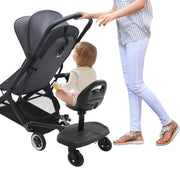 Child sitting in a black stroller with a woman pushing it on a white background