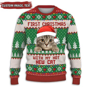 Christmas sweater with a cat design and text 'First Christmas with my hot new cat' on a white background.