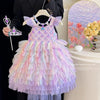 Pastel-colored fairy dress with butterfly wings held on a hanger, with a decorative background.